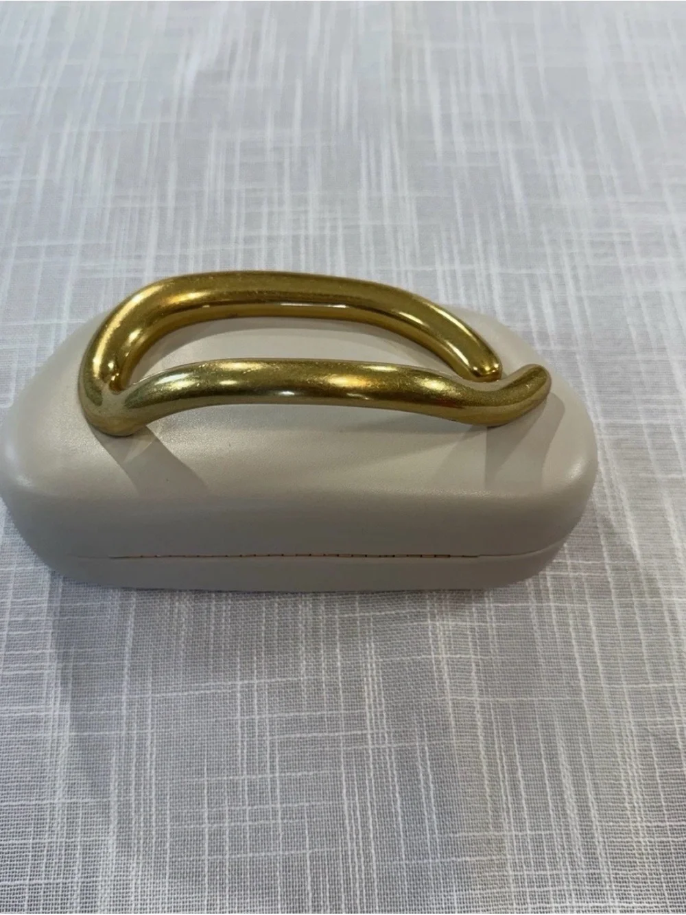 Elegant Cream Clutch with Statement Gold Handle